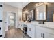 Bathroom vanity with a modern farmhouse design featuring shiplap accent wall and double sinks at 12743 Tahitian Pearl Cir, Parrish, FL 34219