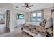 Relaxing bedroom with pond view, a dresser with large TV, and great natural lighting at 12743 Tahitian Pearl Cir, Parrish, FL 34219