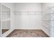 Walk-in closet featuring wire shelving, mirror, and patterned rug on wood-look tile flooring at 12743 Tahitian Pearl Cir, Parrish, FL 34219