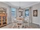 Charming dining room with a round table, six chairs, and large windows with natural light at 12743 Tahitian Pearl Cir, Parrish, FL 34219