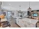 Open-concept kitchen with stainless steel appliances, large island, and views of the dining and living areas at 12743 Tahitian Pearl Cir, Parrish, FL 34219