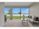 Screened in lanai with brick flooring and serene lake view framed by trees at 12743 Tahitian Pearl Cir, Parrish, FL 34219