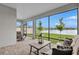 Screened in lanai with brick flooring and serene lake view framed by trees at 12743 Tahitian Pearl Cir, Parrish, FL 34219