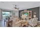 Relaxing living room with a view of the lake, a feature wall, and neutral furniture with stylish decor at 12743 Tahitian Pearl Cir, Parrish, FL 34219