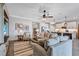 Open floor plan with view of kitchen from living room featuring neutral furniture and hardwood floors at 12743 Tahitian Pearl Cir, Parrish, FL 34219