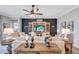 Inviting living room featuring stylish decor, neutral furniture, and a feature wall with built in shelving at 12743 Tahitian Pearl Cir, Parrish, FL 34219