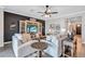 Comfortable living room with a feature wall, neutral furniture, hardwood floors, and accent tables at 12743 Tahitian Pearl Cir, Parrish, FL 34219