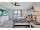 Inviting main bedroom featuring neutral tones, waterfront view, and decorative ceiling fan at 12743 Tahitian Pearl Cir, Parrish, FL 34219