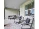 Covered patio features brick flooring and comfortable seating, perfect for outdoor relaxation at 12743 Tahitian Pearl Cir, Parrish, FL 34219