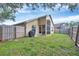 A backyard featuring a patio and grill, enclosed by a wooden fence at 1451 Fawnwood Cir, Sarasota, FL 34232
