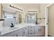 Bathroom with double sinks, granite countertops and a large mirror at 1451 Fawnwood Cir, Sarasota, FL 34232