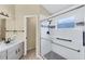 Well-lit bathroom featuring a glass-enclosed shower and modern fixtures at 1451 Fawnwood Cir, Sarasota, FL 34232