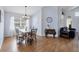 Open dining area with a chandelier, dining set, hardwood floors and lots of natural light at 1451 Fawnwood Cir, Sarasota, FL 34232