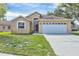 Welcoming single-story home with a well-maintained lawn, and an attached two-car garage, offering a blend of comfort and style at 1451 Fawnwood Cir, Sarasota, FL 34232