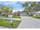 Charming single-story home with a well-manicured lawn and a spacious driveway leading to an attached two-car garage at 1451 Fawnwood Cir, Sarasota, FL 34232