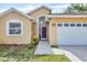 Close-up view of a charming house exterior, highlighting the front entrance and a two-car garage at 1451 Fawnwood Cir, Sarasota, FL 34232