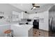 Functional kitchen featuring white cabinets, black appliances, and neutral countertops at 1451 Fawnwood Cir, Sarasota, FL 34232