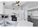 Bright kitchen featuring white cabinetry, stainless steel appliances and a ceiling fan at 1451 Fawnwood Cir, Sarasota, FL 34232