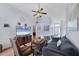 Open living room featuring vaulted ceilings, a ceiling fan, comfortable seating, and wood-look floors at 1451 Fawnwood Cir, Sarasota, FL 34232