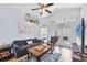 Bright living room with vaulted ceilings, a ceiling fan, and sliding glass doors for indoor-outdoor living at 1451 Fawnwood Cir, Sarasota, FL 34232