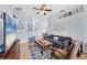 Spacious living room featuring high ceilings, a ceiling fan, comfortable seating, and wood-look flooring at 1451 Fawnwood Cir, Sarasota, FL 34232
