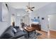 Inviting living room with vaulted ceilings, wood floors, ceiling fan, and bright, neutral wall colors at 1451 Fawnwood Cir, Sarasota, FL 34232