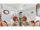 Bright dining room with a glass table, seating for four, and a sliding glass door at 17 Braden Castle Dr, Bradenton, FL 34208
