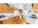 Well-equipped kitchen showcasing wood cabinetry, white appliances, and laminate flooring at 17 Braden Castle Dr, Bradenton, FL 34208