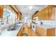 Bright kitchen with wood cabinets, stainless steel sink, white appliances, and laminate wood flooring at 17 Braden Castle Dr, Bradenton, FL 34208