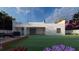 The backyard has a modern home, a plush lawn, a wooden deck with seating, and privacy fence at 17461 Dudley Ave, Port Charlotte, FL 33954