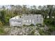Construction of a cinder block house in wooded area shows foundation, block walls, and garage support at 17461 Dudley Ave, Port Charlotte, FL 33954