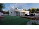 Modern home showcasing a spacious yard, sleek architectural design, and outdoor seating on a wooden deck at 17461 Dudley Ave, Port Charlotte, FL 33954