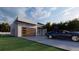 Contemporary home with a modern garage door, a sleek driveway, and an inviting facade at 17461 Dudley Ave, Port Charlotte, FL 33954