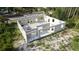 Angled aerial view of an unfinished single-Gathering home showcasing its block construction and initial layout at 17461 Dudley Ave, Port Charlotte, FL 33954