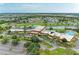Great aerial view showcasing the community building with a pool, pond, and convenient parking at 1906 Canterbury Ln # 16, Sun City Center, FL 33573