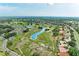 Scenic aerial view of the community's lush green landscape, water features, and cozy residential homes at 1906 Canterbury Ln # 16, Sun City Center, FL 33573