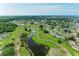 Aerial of community showing ponds, mature trees, well-maintained landscaping and quaint residential streets at 1906 Canterbury Ln # 16, Sun City Center, FL 33573