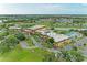 Beautiful aerial shot of the community building with landscaped grounds, pool, and pond offering serene views at 1906 Canterbury Ln # 16, Sun City Center, FL 33573