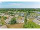 Overview of neighborhood featuring nicely spaced homes, green lawns, mature trees, and community landscaping at 1906 Canterbury Ln # 16, Sun City Center, FL 33573