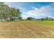 Large backyard with mature trees and well-maintained lawns, ideal for outdoor activities at 1906 Canterbury Ln # 16, Sun City Center, FL 33573