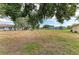 Expansive backyard of this home with well-maintained lawn and mature trees offering shade at 1906 Canterbury Ln # 16, Sun City Center, FL 33573