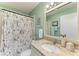 Bathroom featuring a granite countertop, decorative shower curtain, and stylish decor at 1906 Canterbury Ln # 16, Sun City Center, FL 33573