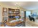 Charming dining area with a wooden table and bookshelf, perfect for Gathering gatherings at 1906 Canterbury Ln # 16, Sun City Center, FL 33573