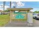 Cambridge Villas entrance sign showcasing the community name and address with lush landscaping at 1906 Canterbury Ln # 16, Sun City Center, FL 33573