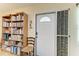 Bright entryway featuring a white door, a bookshelf, and a cozy chair at 1906 Canterbury Ln # 16, Sun City Center, FL 33573