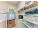 Functional laundry area with ample storage, a window, and modern machines at 1906 Canterbury Ln # 16, Sun City Center, FL 33573