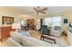 Spacious living room featuring hardwood floors, comfortable seating, and a dining area in the background at 1906 Canterbury Ln # 16, Sun City Center, FL 33573
