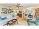 Inviting living room featuring hardwood floors, a ceiling fan, and bright, sunny ambiance at 1906 Canterbury Ln # 16, Sun City Center, FL 33573