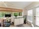 Enclosed sunroom with tile floors, a ceiling fan, and views of the lush yard at 1906 Canterbury Ln # 16, Sun City Center, FL 33573