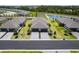 An aerial view of the neighborhood showcasing well-manicured lawns, a pond, and charming single-Gathering homes at 2016 Bonito Way, Port Charlotte, FL 33953